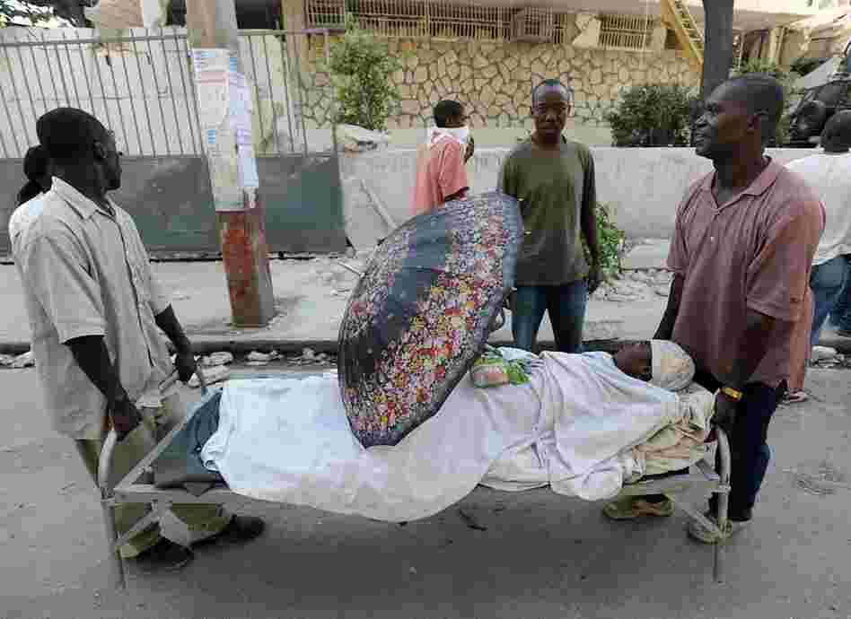 Men carry an injured relative in Port-au-Prince. The Haitian Red Cross estimates that more than 50,000 people may have been killed in the earthquake. 