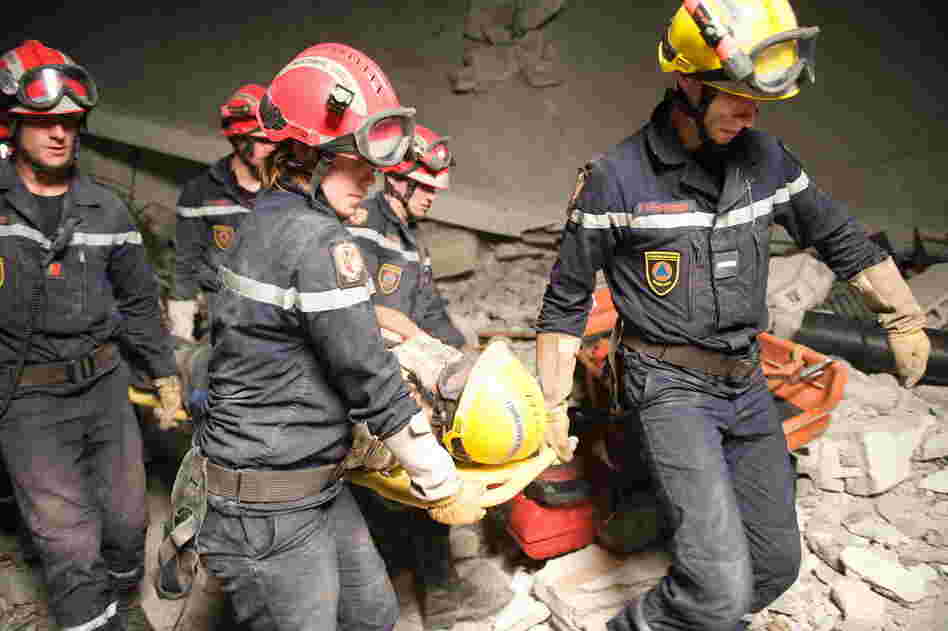After 50 hours trapped, James Girly, 64, is rescued from the remains of the Montana Hotel by the French military.  (Nicholas Kamm/AFP/Getty Images