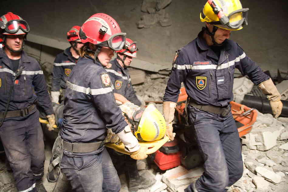 After 50 hours trapped, James Girly, 64, is rescued from the remains of the Montana Hotel by the French military.  (Nicholas Kamm/AFP/Getty Images