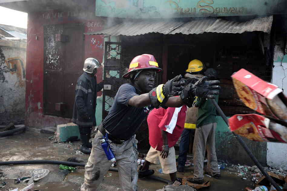 Fireman attempt to put out a blaze in Port-au-Prince Thursday. 