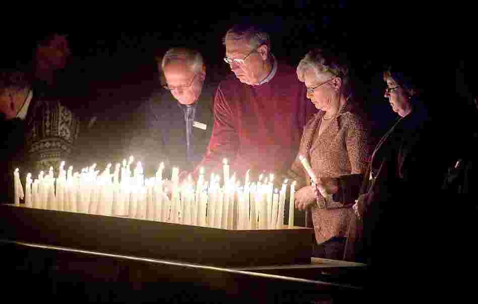 Members of the congregation of First Lutheran Church in Duluth, Minn. pray for the earthquake victims Thursday. The pastor's son is believed to have been killed in the quake. 