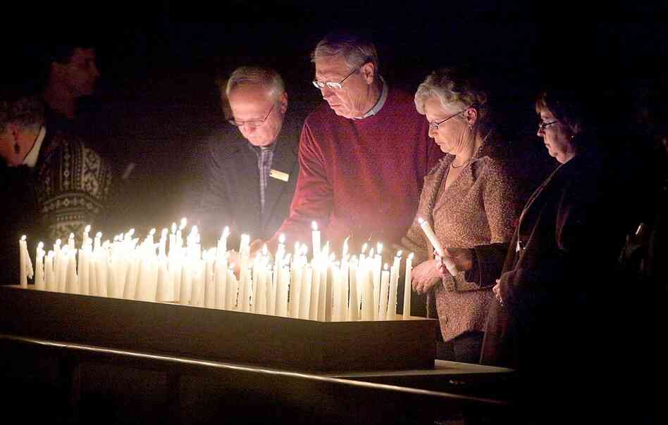 Members of the congregation of First Lutheran Church in Duluth, Minn. pray for the earthquake victims Thursday. The pastor's son is believed to have been killed in the quake. 