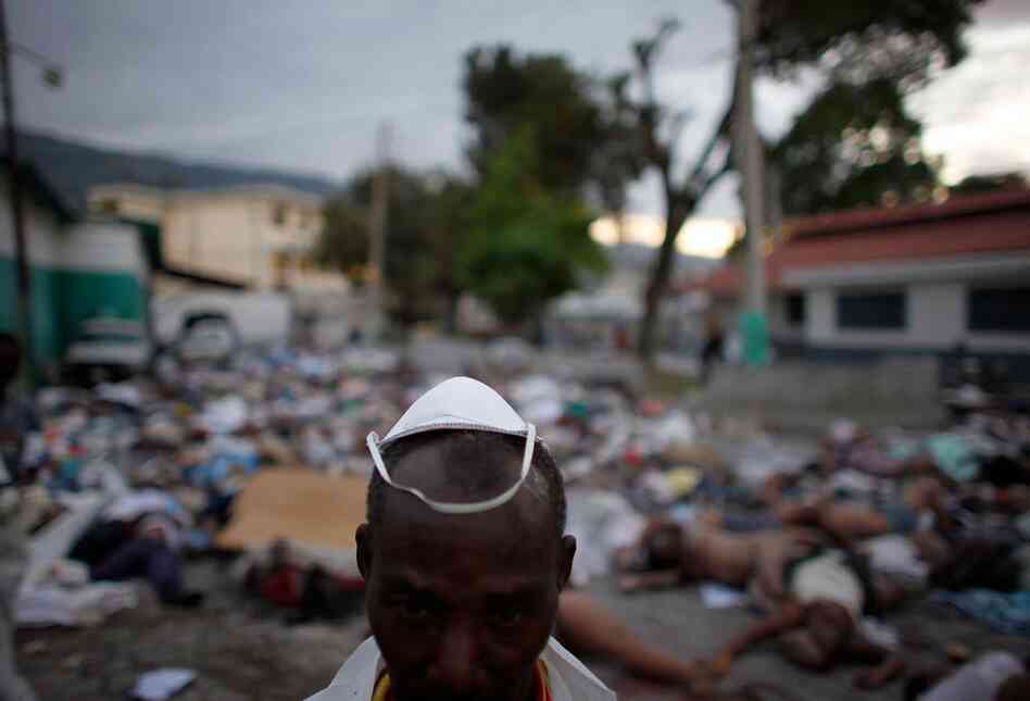 As of Thursday, as many as 50,000 people had died in the earthquake, according to an estimate from the Haitian Red Cross. A morgue worker stands amid the devastation.