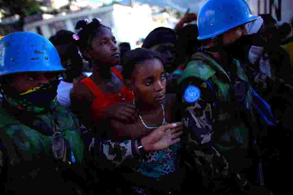 Women stand in line for food rations being handed out by the United Nations Friday in Port-au-Prince.