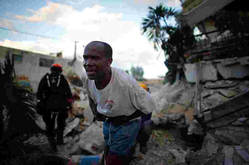 The search for people in the rubble continues. A Haitian rescue worker helps the L.A. County Search and Rescue team in in downtown Port-au-Prince.