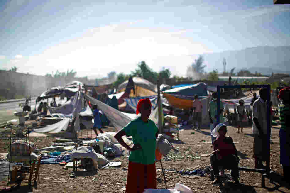 Refugees wait in a makeshift camp Saturday near downtown Port-au-Prince.