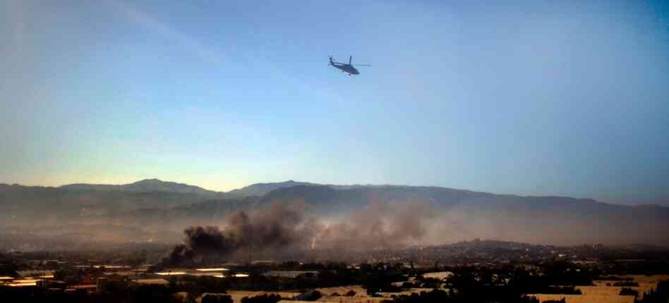 A U.S. Navy helicopter flies over Port-au-Prince on Monday.