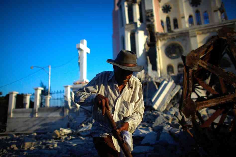 A man walks past Our Lady of Assumption Catholic Church in downtown Port-au-Prince.