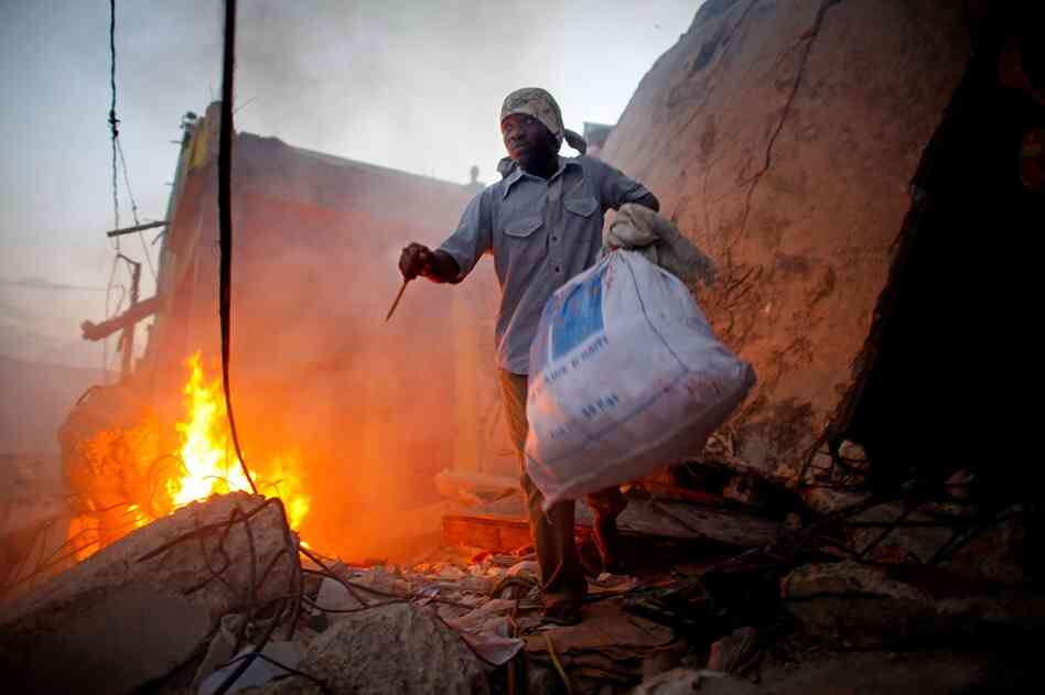 He emerges with a bag of goods, prepared to defend himself from others seeking food.