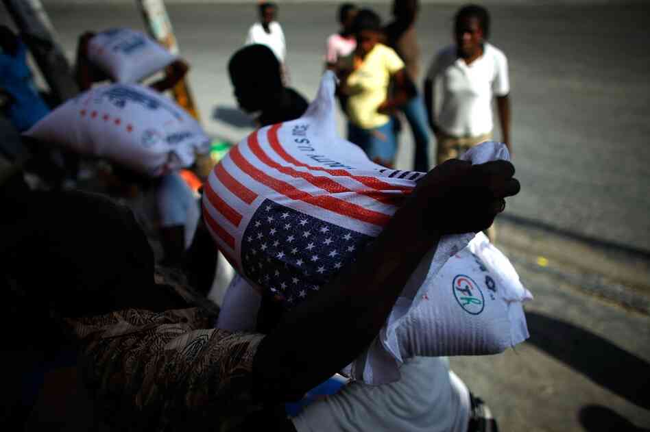 Haitians gather outside a store to buy rice and wheat in downtown Port-au-Prince. Food is scarce and prices have skyrocketed since Tuesday.