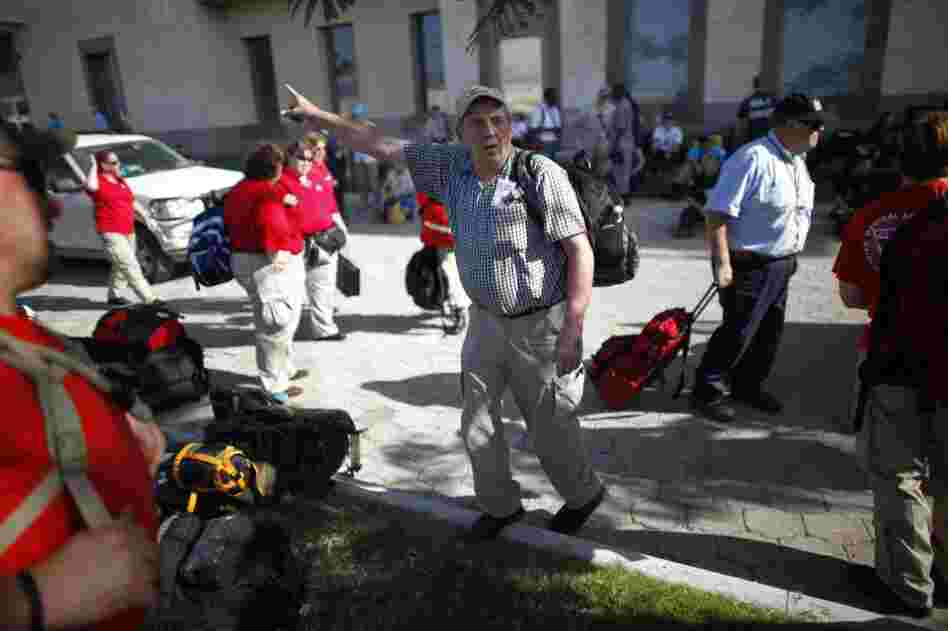 Lou Raeder, the logistics specialist for the Georgia team, helps direct personnel Sunday on the grounds of the American Embassy in Port-au-Prince.