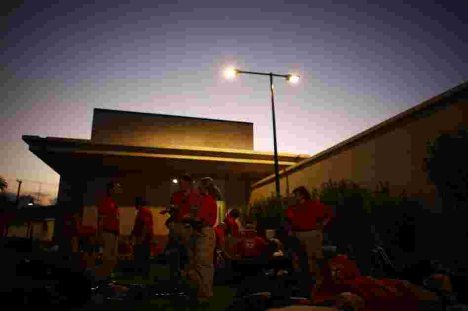 The team settles in for the evening outside the embassy. They hope to get into the field soon, but still don't have the military protection they are told they need.