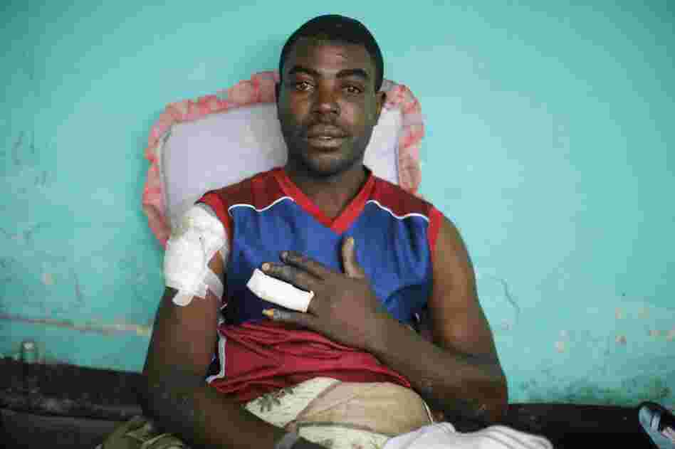 A patient waits for treatment Tuesday at a field hospital set up by emergency medical teams in downtown Port-au-Prince. 