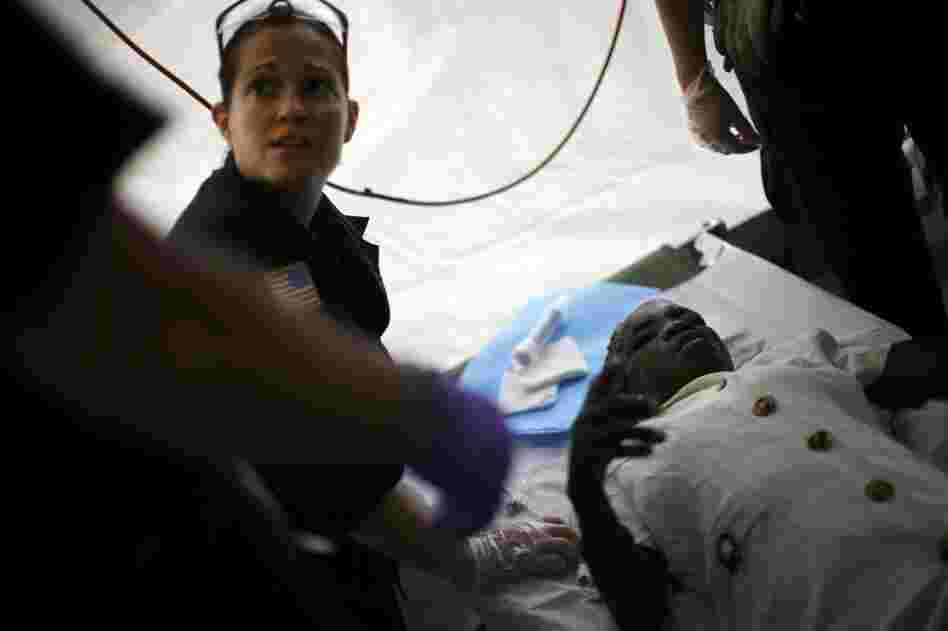 Physician's assistant Courtney Shores treats a patient with a head wound.