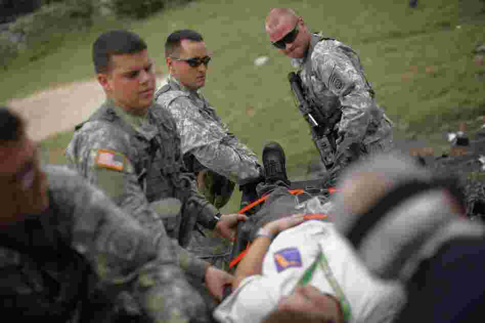 Members of the 82nd Airborne division carry nurse Yamile Fuentes to a helicopter for evacuation owing to an unspecified medical condition.