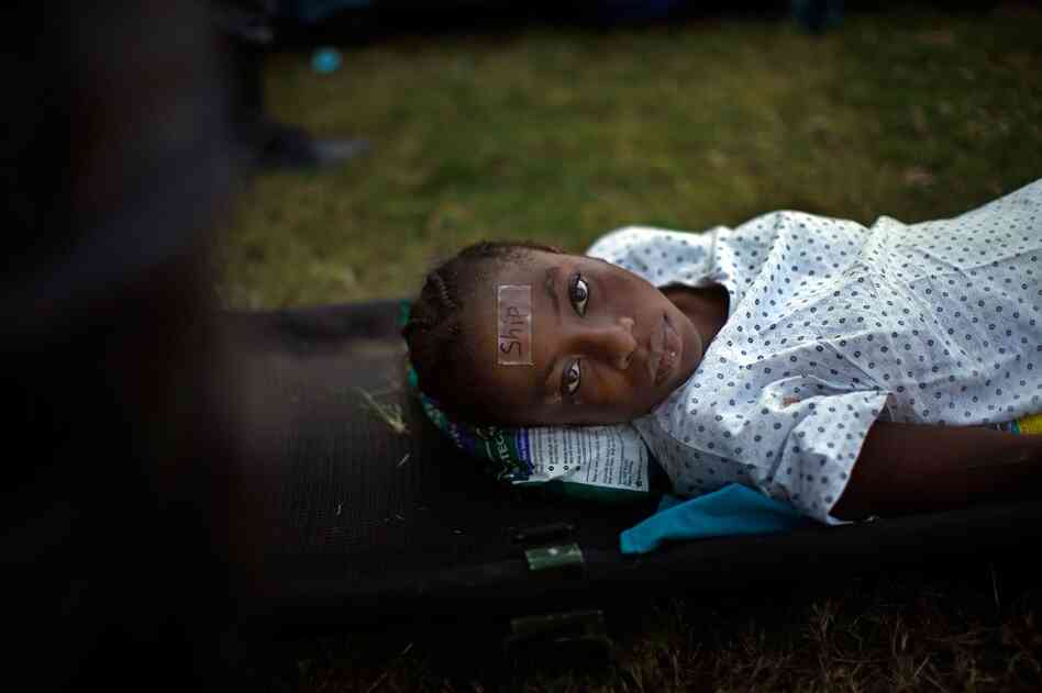 A girl wears a tag that identifies her as a transfer patient to the USNS Comfort off the shore of Haiti.