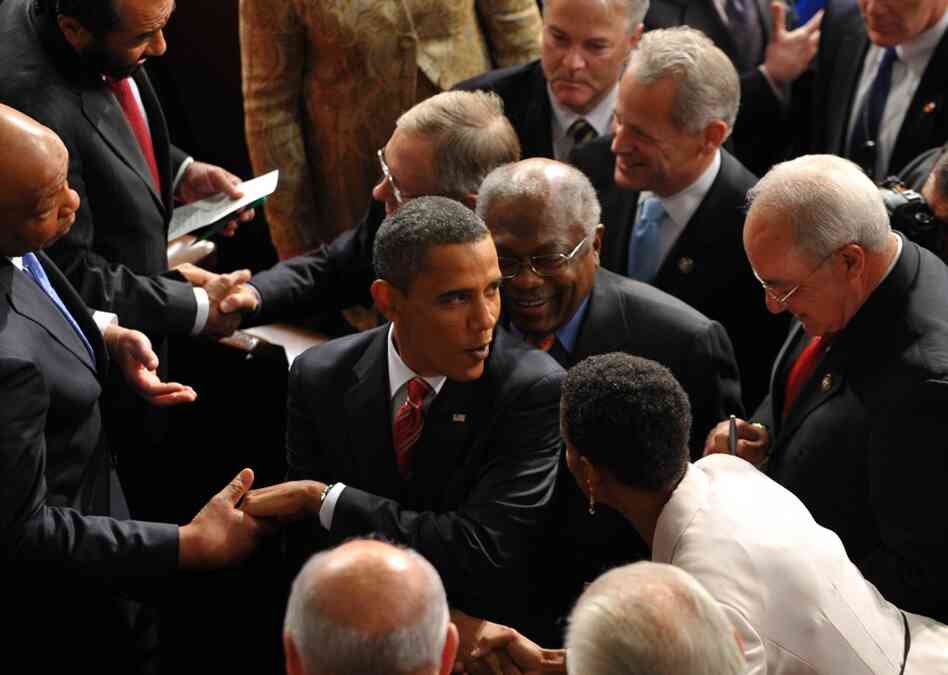 The president shakes hands on his way out of the chamber following his speech. 