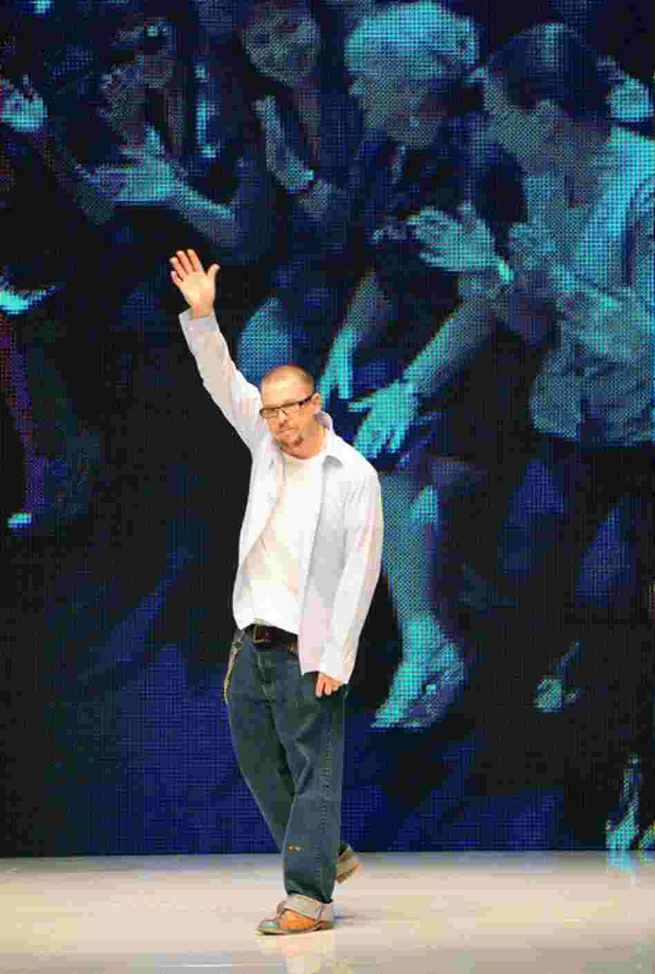 McQueen waves to an audience at his Pret a Porter show during the Paris Womenswear Fashion Week Spring/Summer 2010 in June 2009. 