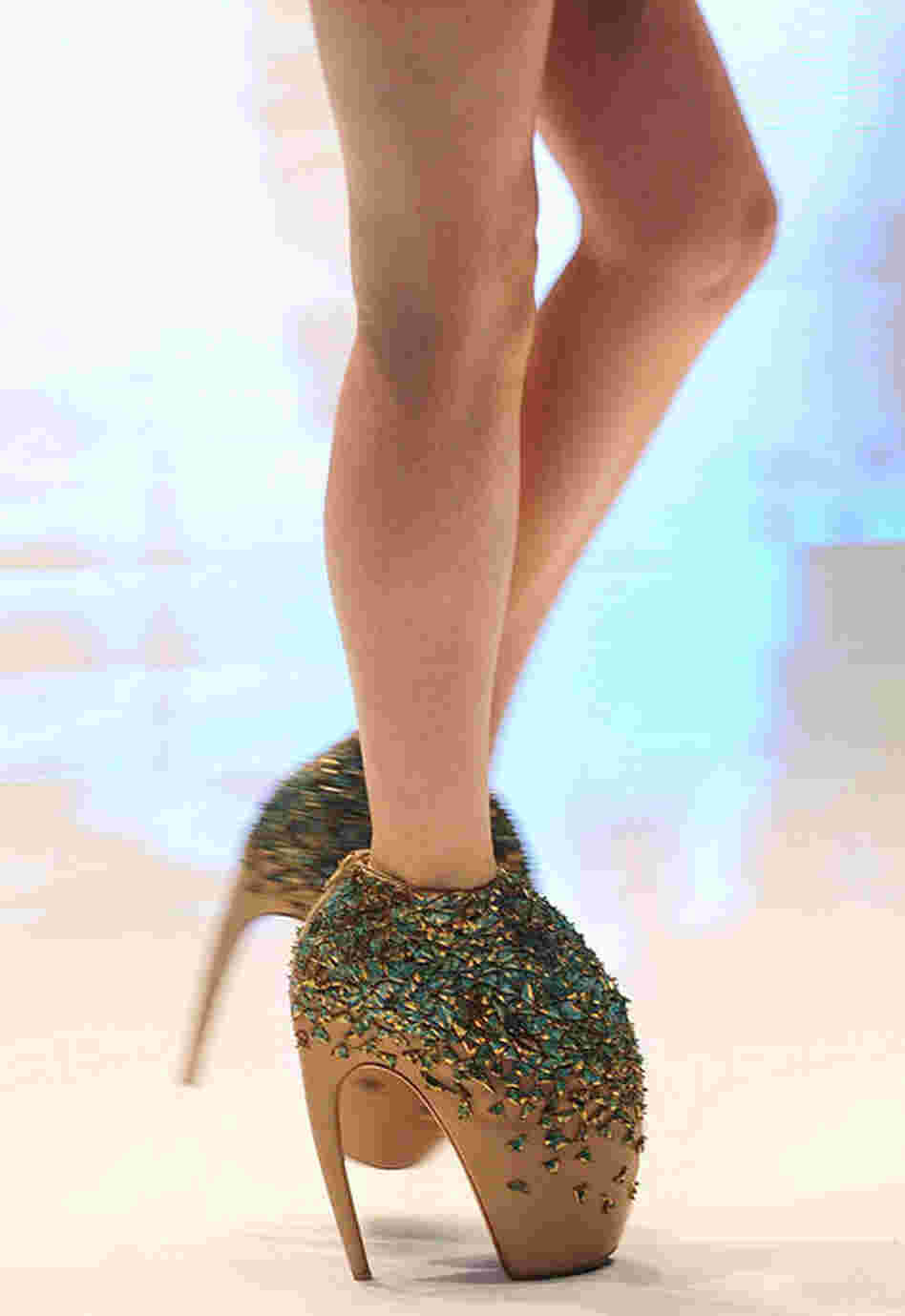 McQueen's originality was not only limited to his textile creations. A model wears a pair of McQueen's "armadillo" shoes at the Paris Womenswear Fashion Week in June 2009. 