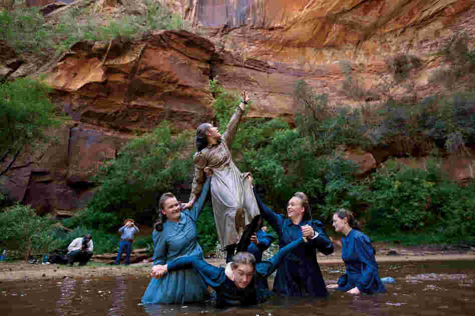 Female FLDS members wear modest attire like ankle-length prairie dresses, even while swimming. "It can get kind of cold," says Verda Shapley, 19, reaching for a cable trolley with her sisters at a pond near Hildale. "We do everything together," says their father, William (at left). "The foundation of this life is your belief in a life after this."