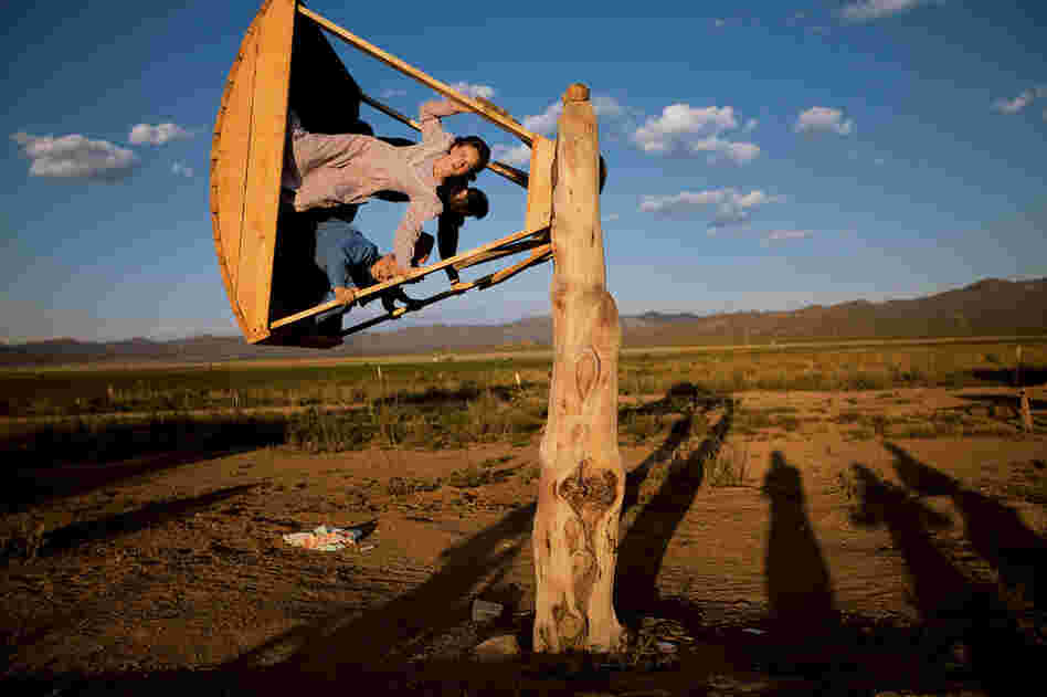 After helping with the hay harvest, Amber Barlow, 16, soars on a homemade swing with friends at the 4,000-acre FLDS ranch in Pony Springs. FLDS members, even young children, are expected to help with chores throughout the year.