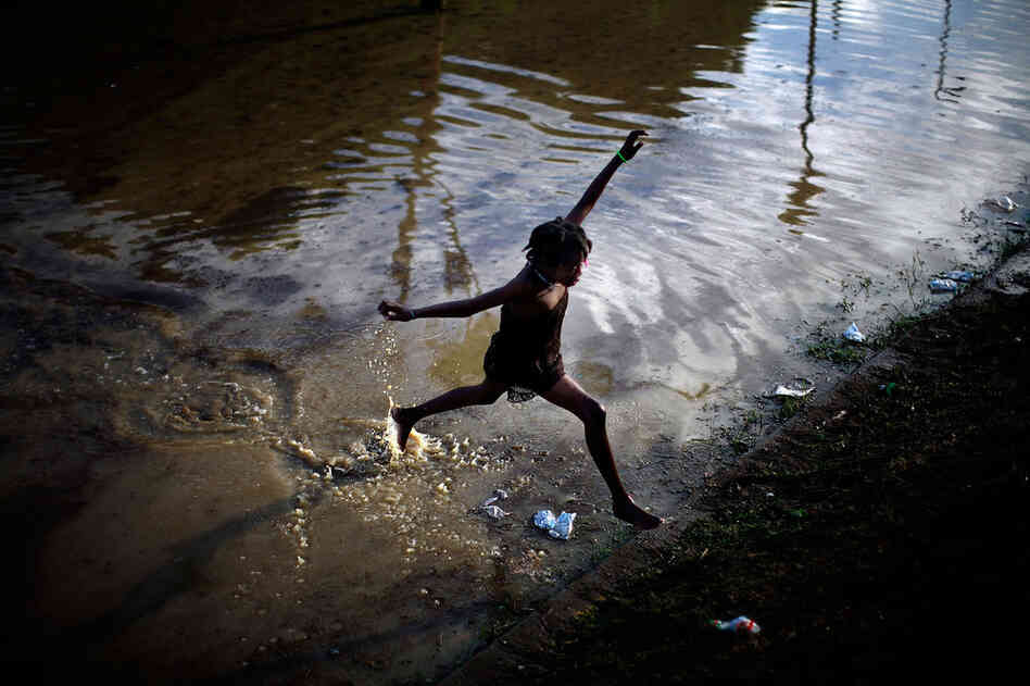 As if the Jan. 12 earthquake weren't devastating enough, Haiti now faces the rainy season, which usually begins in late spring. After heavy rains overnight Wednesday and Thursday, a girl jumps across a flooded field containing the sewage runoff from the Mais Gate tent city near the airport in Port-au-Prince. 
