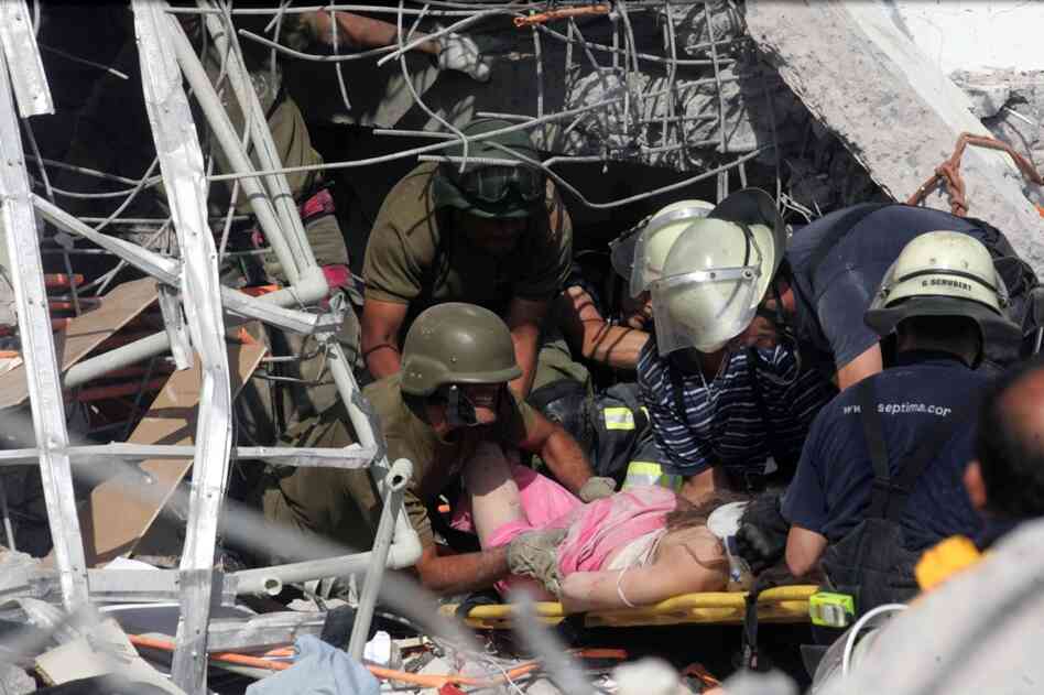 Rescue workers help an injured woman in Concepcion. 