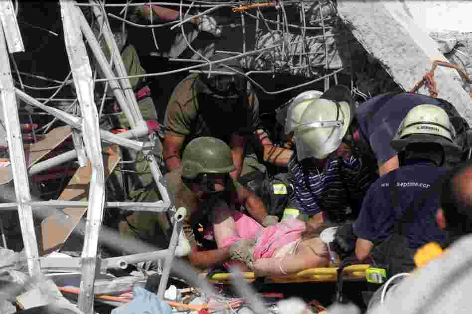 Rescue workers help an injured woman in Concepcion. 