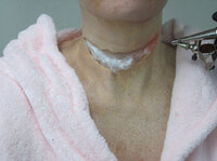 Cotton is placed into the slit of the latex, so that makeup artist Jerry Constantine can prepare the neck for what he calls