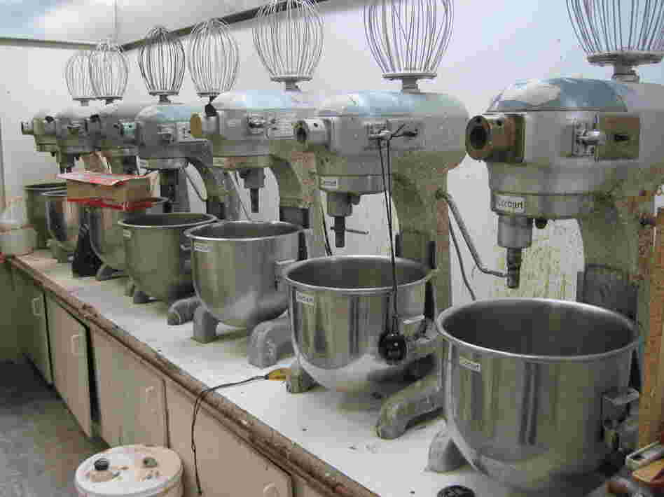 Seven mixers sit at the ready in a climate-controlled room. They are used for mixing foam — the first stage for making glue-on prosthetic devices.