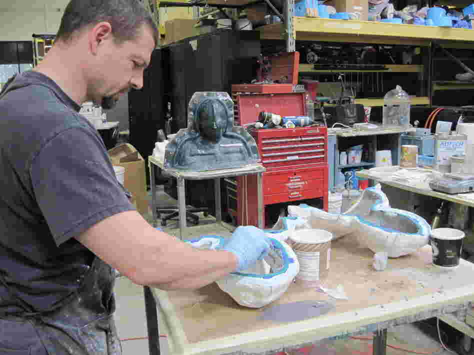 The mixed foam is then set in molds, baked and peeled out.  Here, a technician constructs facial parts for the upcoming film Thor.