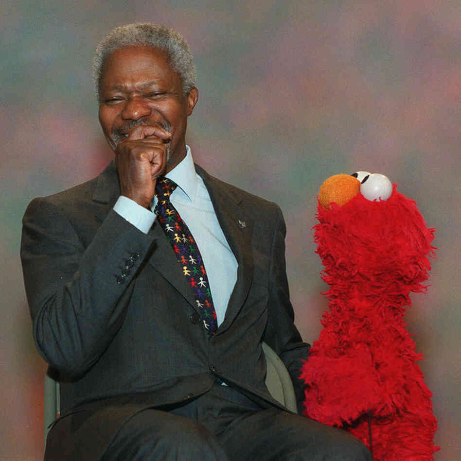United Nations Secretary-General Kofi Annan laughs while taping a scene with Elmo during production of an episode of Sesame Street, Dec. 6, 2001. Annan offered Elmo a job at the United Nations and Elmo asked if he could win a Nobel prize, too.