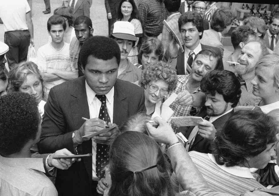 Former heavyweight champion Muhammad Ali signs autographs in New York, Sept. 15, 1982.