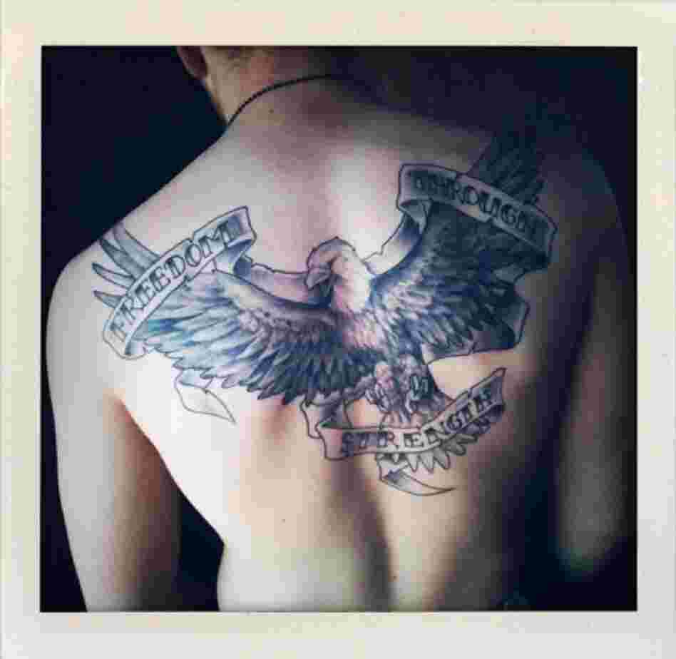 A tattoo covers the back of a U.S. Marine.