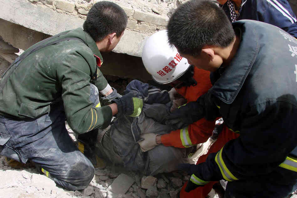 Rescue workers pull out a person from a collapsed building in Yushu. The largest earthquake struck at 7:49 a.m. local time and had a magnitude of 6.9, according to the U.S. Geological Survey. 