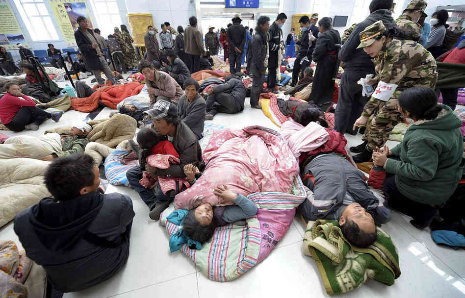 Injured survivors take refuge at Yushu airport as they wait for medical attention and transfer. Reports circulated that virtually the entire population of Yushu county have had to be moved to safety. 