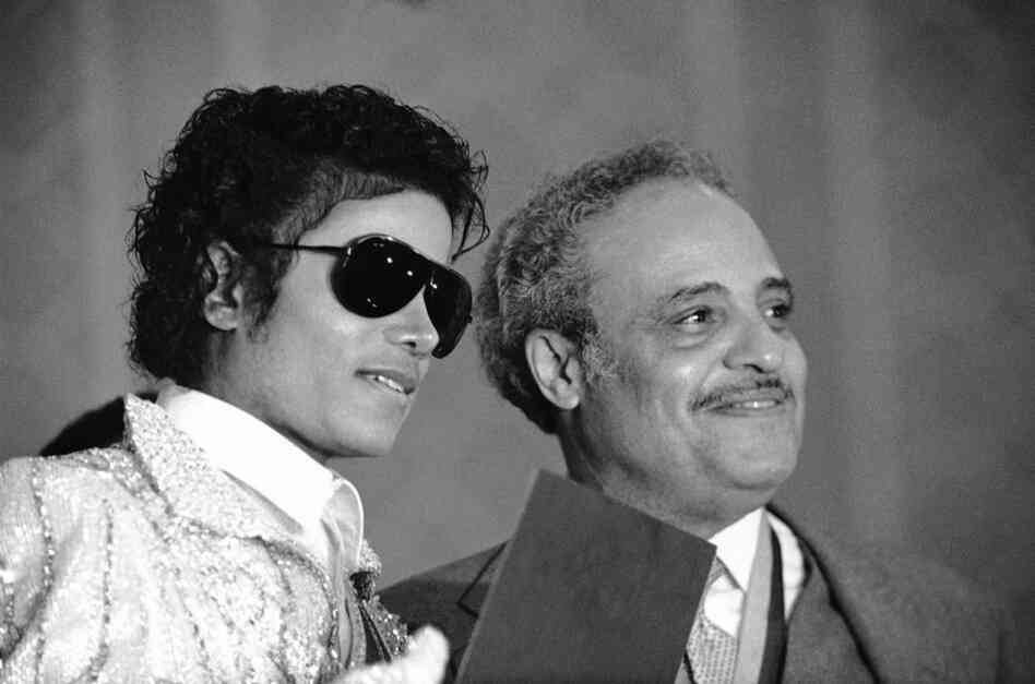 Hooks presents the Dr. H. Claude Hudson Medal of Freedom Award and the 1984 Olympics Medal of Friendship Award to the Jackson family, represented by Michael Jackson, on July 6, 1984. 