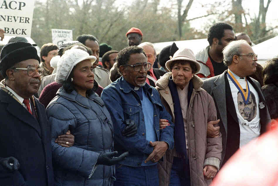 Coretta Scott King (second from left), Southern Christian Leadership Council President Joseph Lowery and his wife (center), and Hooks (right) march to the Forsyth County Courthouse in Cumming, Ga., as part of a demonstration against white supremacists on Jan. 24, 1987. 