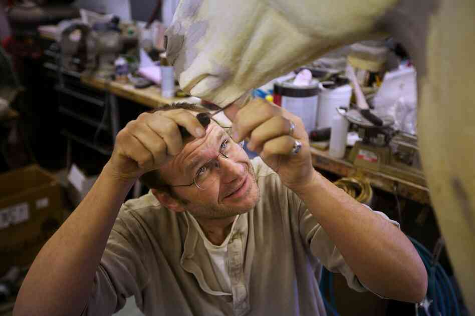 Working in his taxidermy studio in Point of Rocks, Md., Rhymer uses a knife to adjust the shape of the Styrofoam form on which he will mount a Burchell's zebra.
