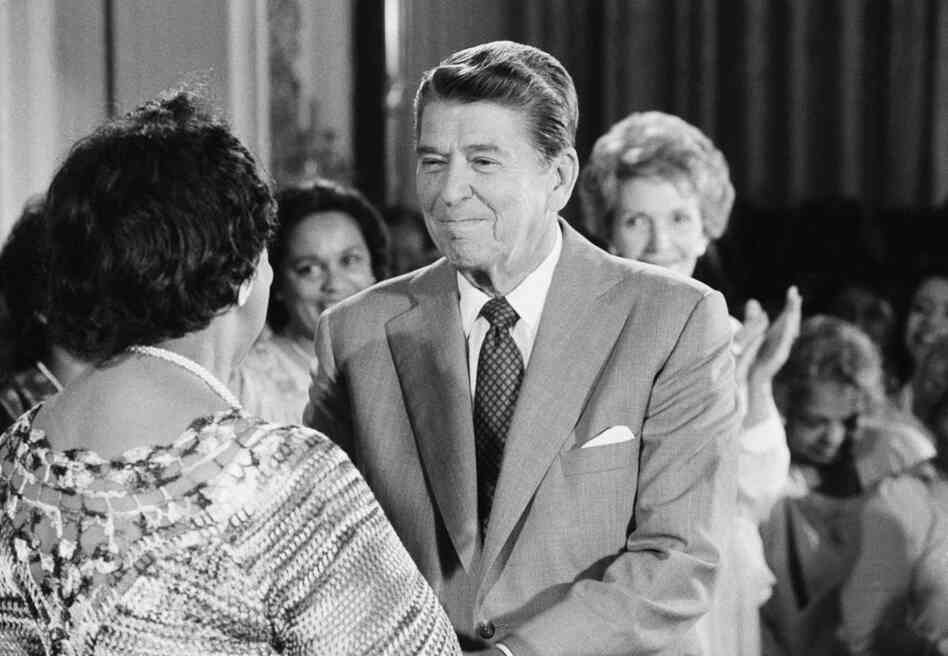 President and Mrs. Reagan greet Height during a White House East Room reception on Thursday, July 28, 1983. 