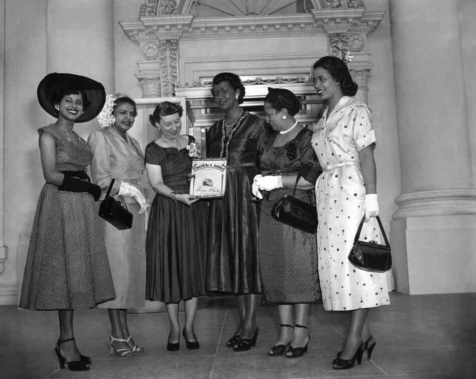 Height (third from right) and other members of Delta Sigma Theta Sorority Inc. present Mamie Eisenhower with a copy of their song, "There'll be a Jubilee," on May 14, 1953. Height was national president of the sorority from 1946-1957. 