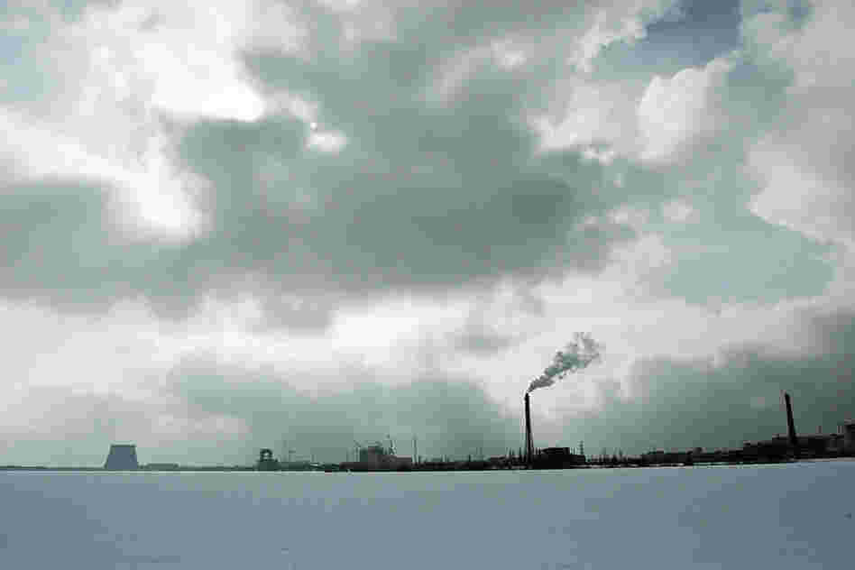 "This view of the sprawling Chernobyl Nuclear Power Plant is from the far bank of the plant's cooling pond during winter. The population within 30 kilometers was permanently evacuated, including residents of Pripyat and many villages."