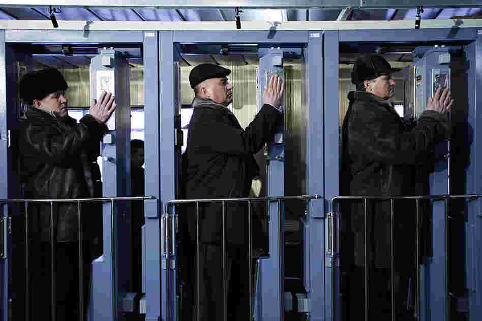 "Although the Chernobyl Nuclear Power Plant stopped generating electricity in December 2000, today 3,800 employees continue to work at the plant, commuting from the new city of Slavutych. Workers must pass through a radiation checkpoint each day before they board the train home."