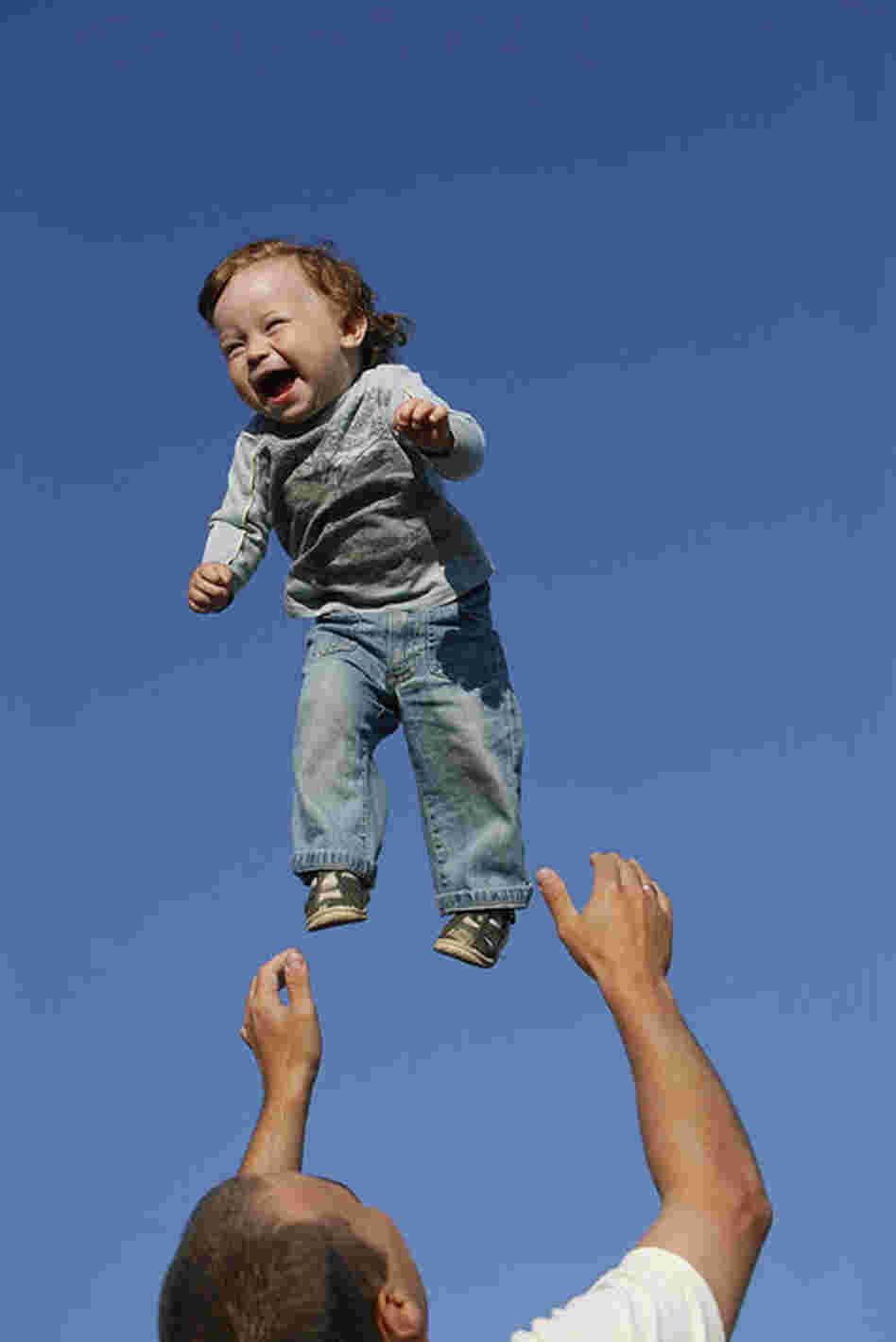 "Andrei Balta throws his fifteen-month-old son Vanya in the air during a summer evening in Slavutych, Ukraine. Every evening, parents with babies and toddlers gather in the central square of Slavutych to socialize. Andrei and his wife Anna both work at the nearby Chernobyl Nuclear Power Plant, as do over 3,800 residents of Slavutych."