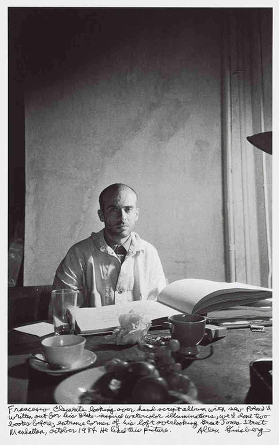 "Franceso Clemente looking over hand-script album with new poem I'd written out for his Blake-inspired watercolor illuminations, we'd done two books before; entrance corner of his loft overlooking Great Jones Street Manhattan, October 1984. He liked this picture."