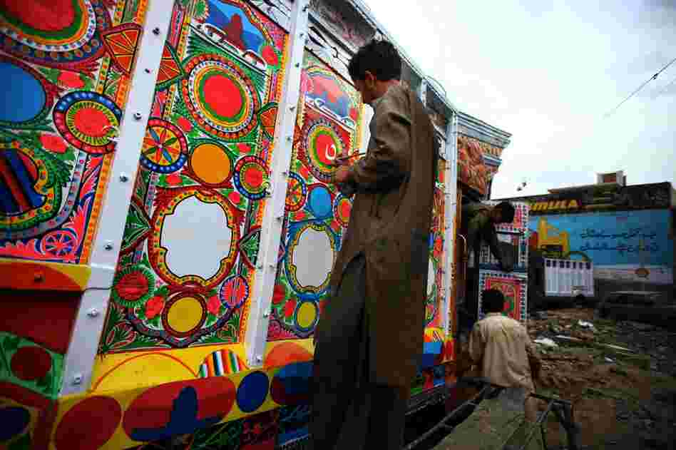 Artist Mohammad Saeed, 32, works on the details of a truck. Nearly all trucks driving on the Grand Trunk Road are fully painted inside and out, with tin and wood details and a huge decorated hood above the driver's cab. 
