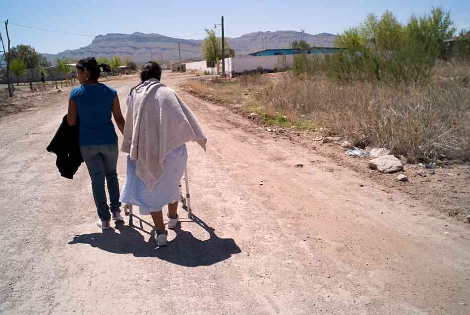 A woman (right), whose son was kidnapped and executed in August 2009, is one of thousands of people living in the Juarez Valley. Like many, she said she feels trapped there. 