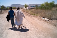 A woman (right), whose son was kidnapped and executed in August 2009, is one of thousands of people living in the Juarez Valley. Like many, she said she feels trapped there.