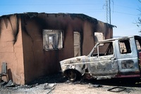 Armed men set fire to several houses and killed one man in the town of La Esperanza.