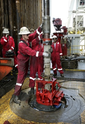 Workers adjust piping while drilling a relief well at the site of the Deepwater Horizon oil spill.